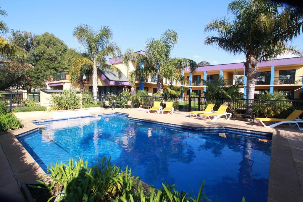 a swimming pool in front of a hotel at Nautilus Apartments Merimbula in Merimbula