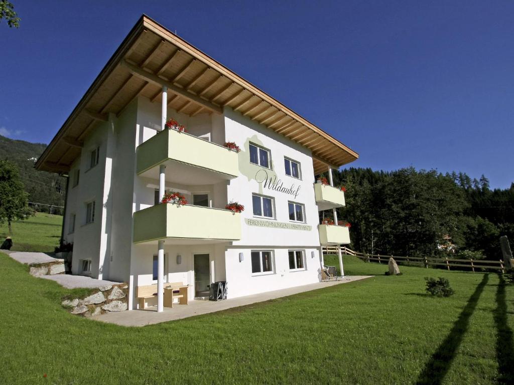 a large white building in a field with grass at Spacious Apartment with Sauna in F gen in Fügen