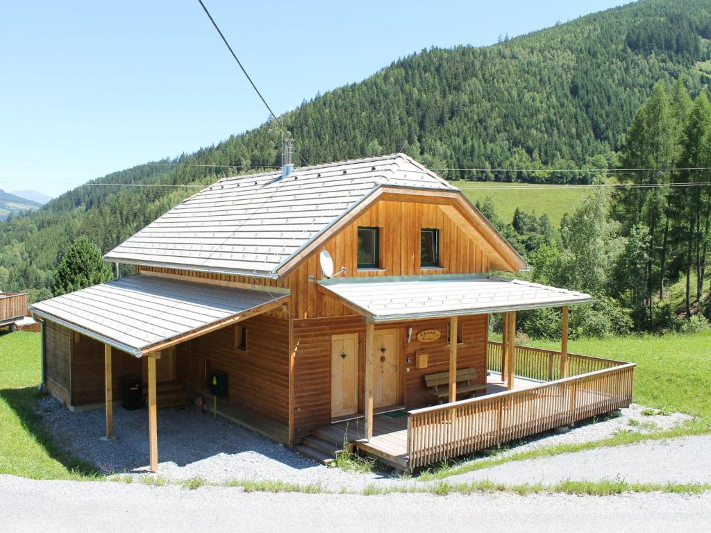 a house with a metal roof on top of it at Chalet in Stadl an der Mur with sauna in Stadl an der Mur