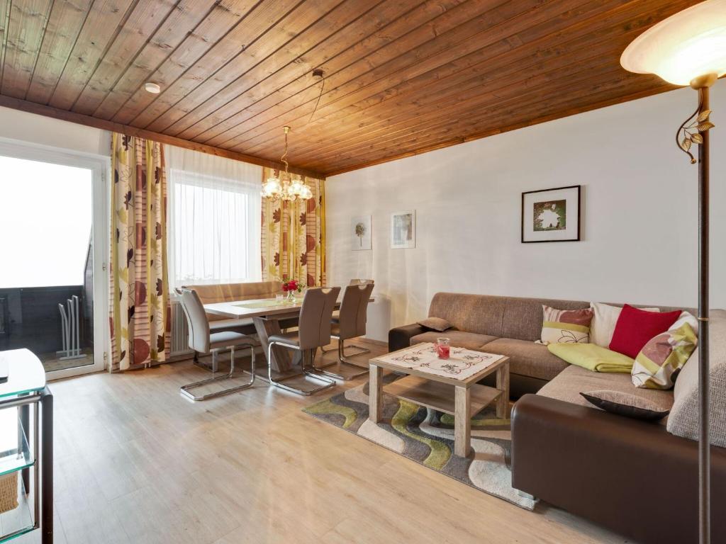 a living room with a couch and a table at Spacious Apartment in Afritz am See near Ski Area in Afritz