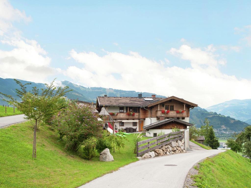 a house on a hill next to a road at Apartment in Kaprun near the ski area in Kaprun