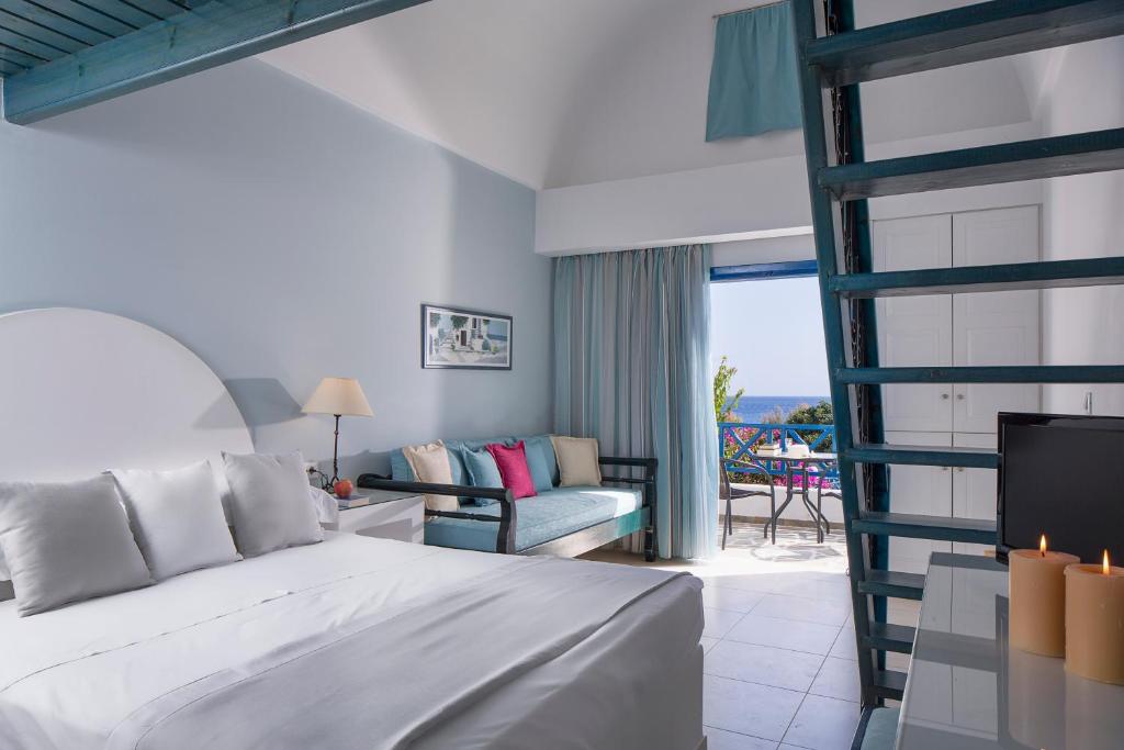 A bed or beds in a room at Veggera Beach Hotel