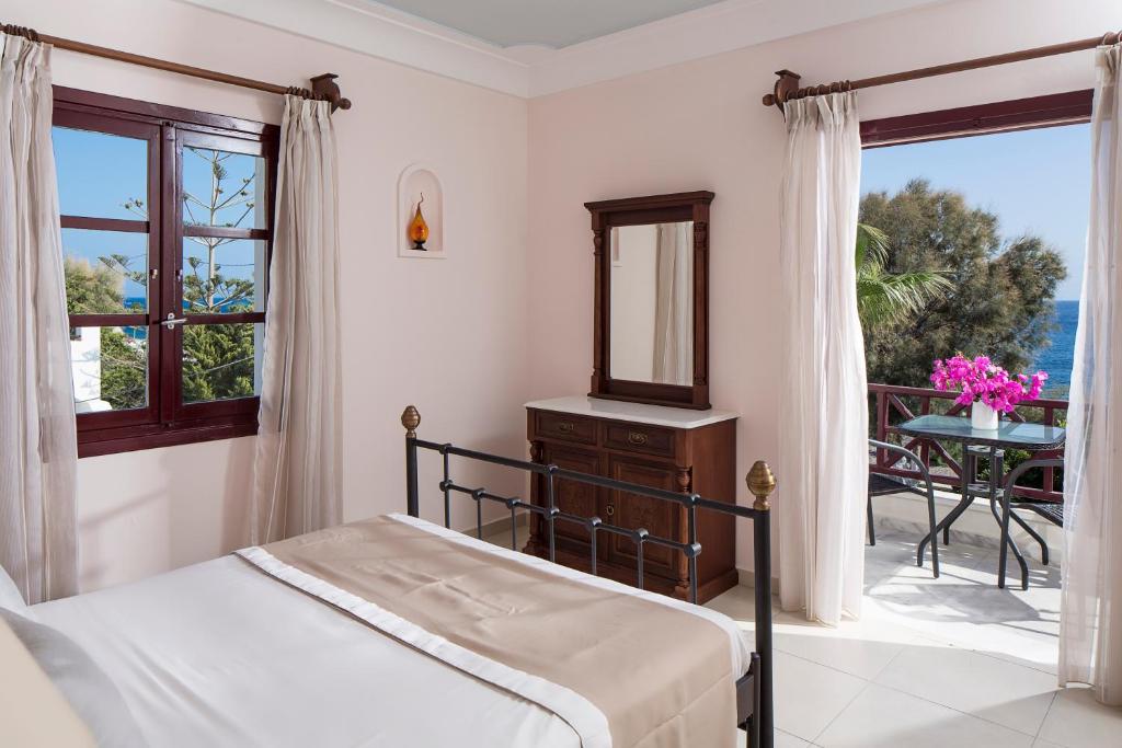 A bed or beds in a room at Veggera Beach Hotel