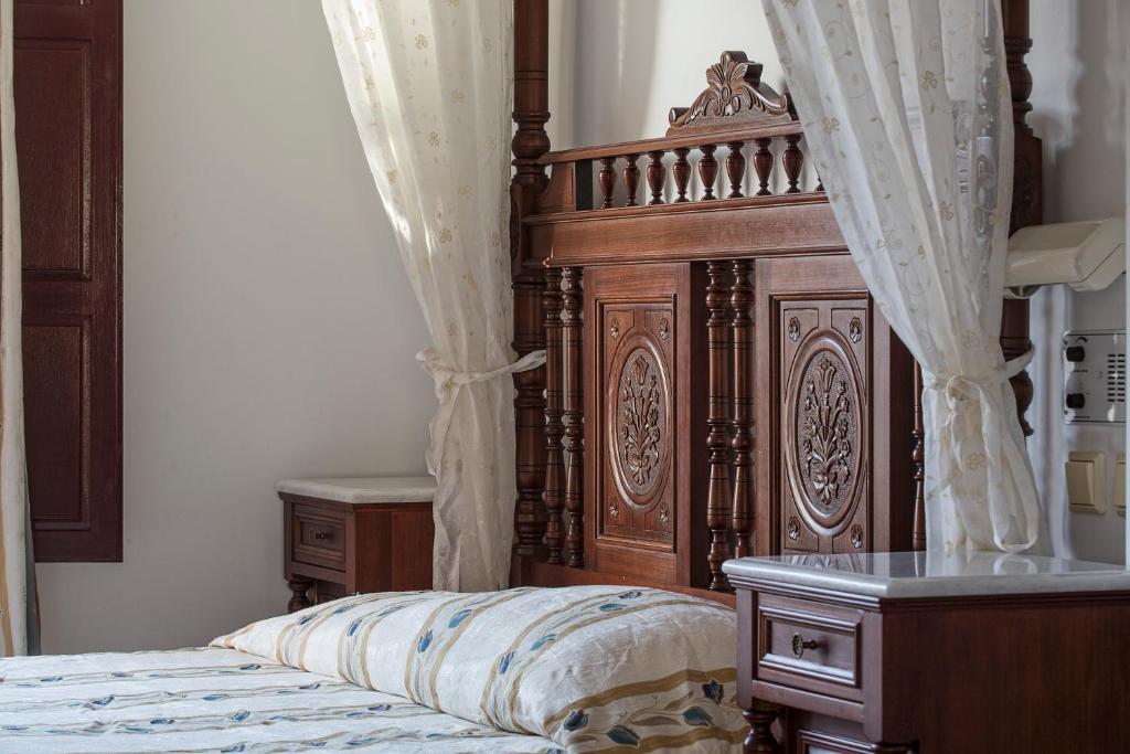 A bed or beds in a room at Veggera Beach Hotel