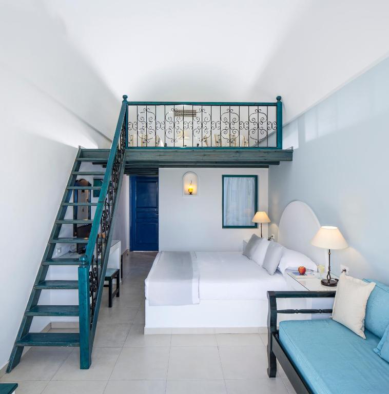 A bed or beds in a room at Veggera Beach Hotel