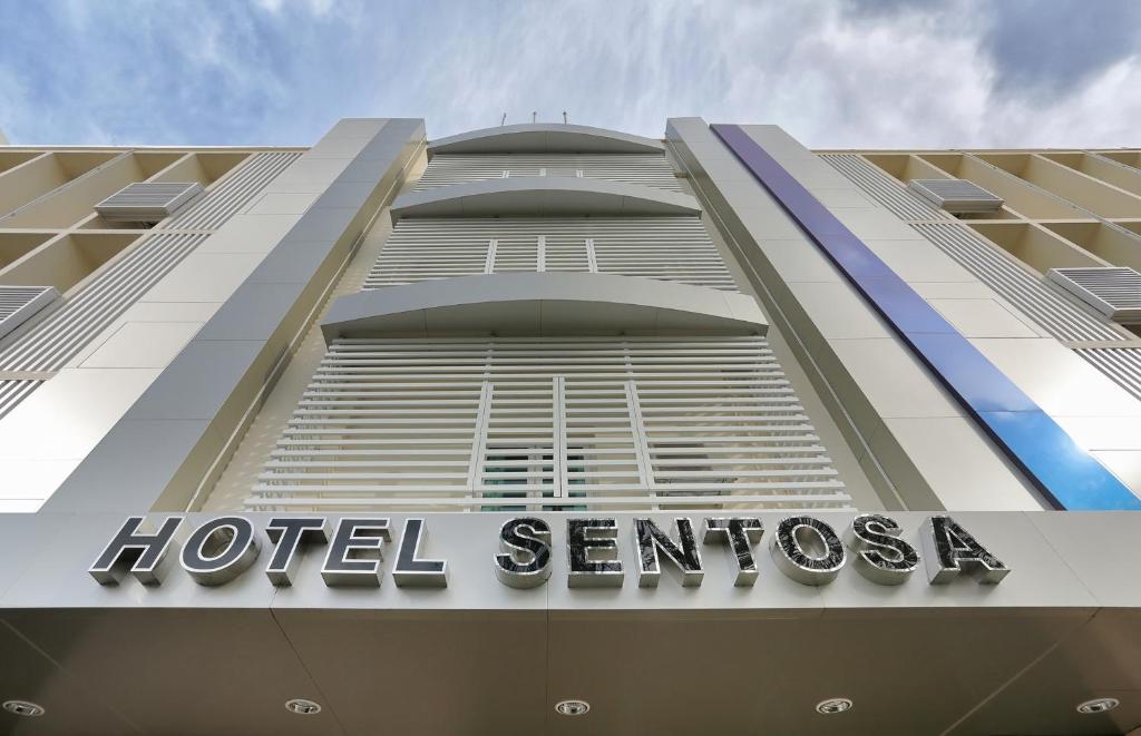 a hotel sign on the side of a building at Hotel Sentosa in Kuala Belait