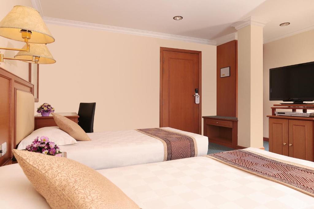 Postel nebo postele na pokoji v ubytování Hotel Sentosa