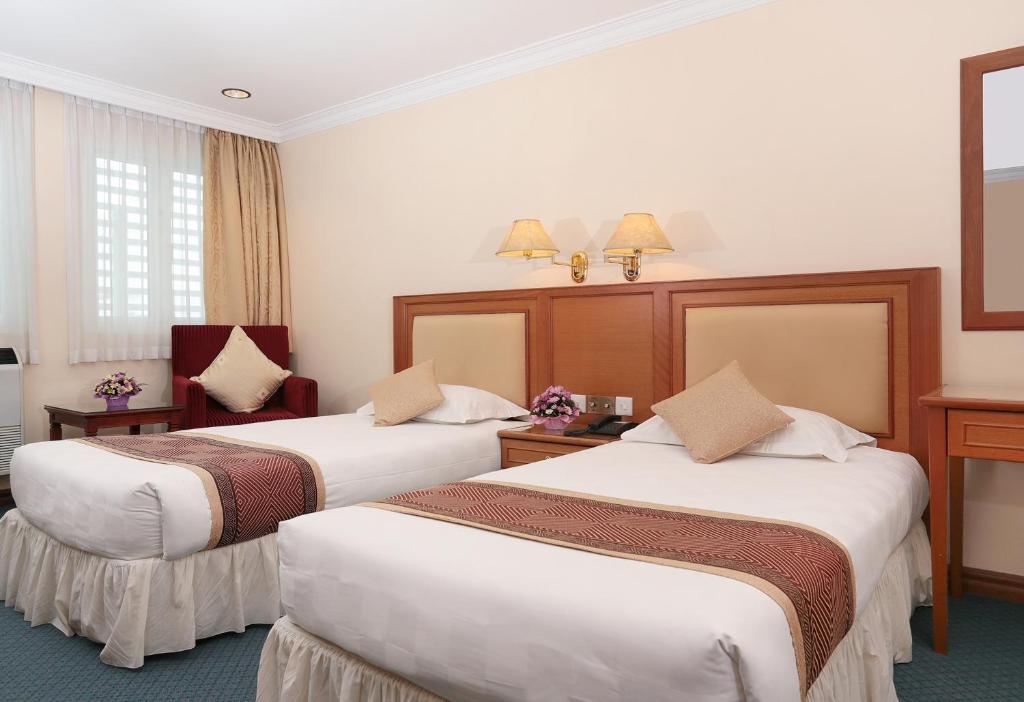 Postel nebo postele na pokoji v ubytování Hotel Sentosa