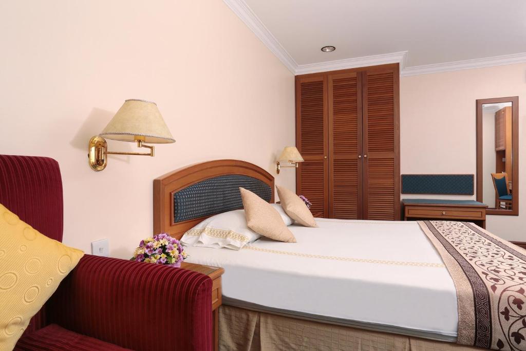 Postel nebo postele na pokoji v ubytování Hotel Sentosa
