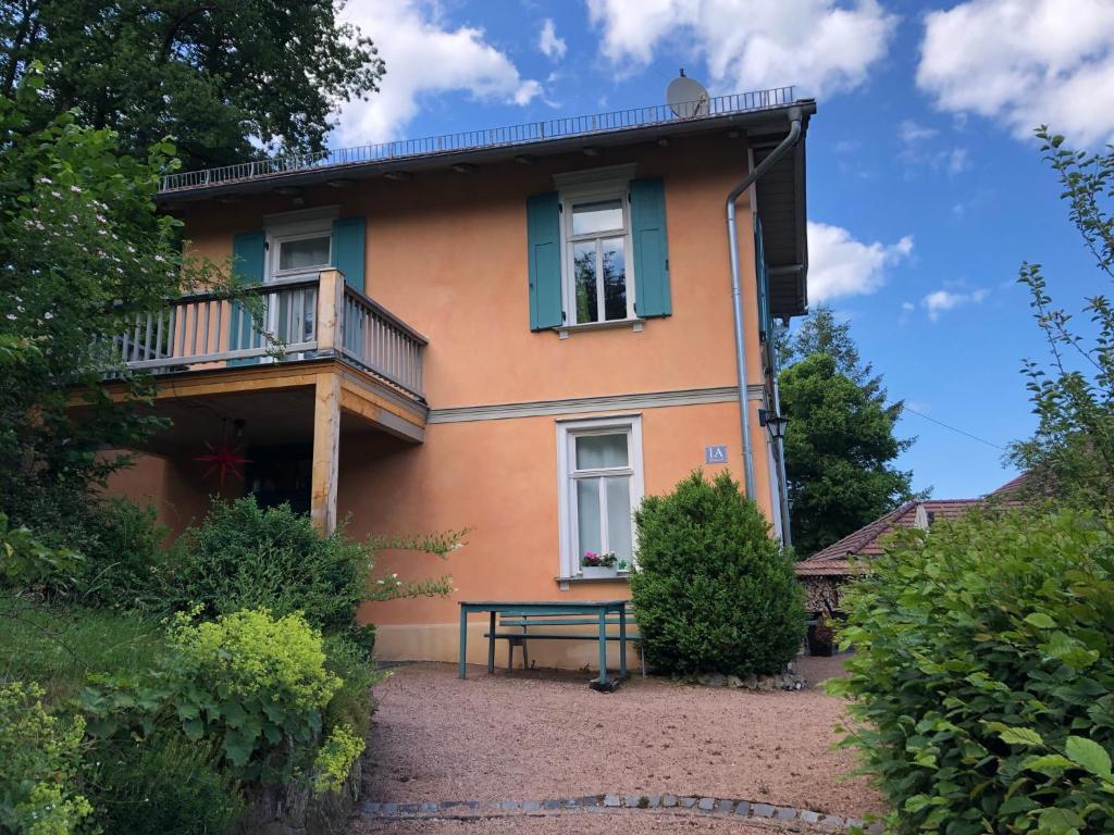 a house with a balcony and a bench in front of it at Ferienhaus Eisenach in Eisenach