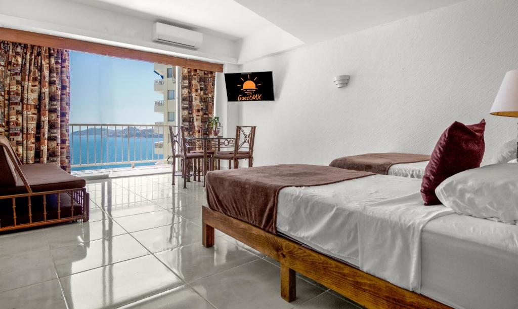Postel nebo postele na pokoji v ubytování Suites Torres Gemelas VIP