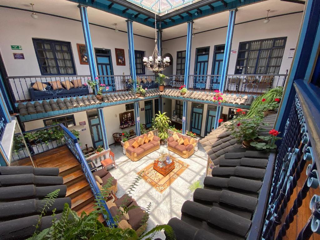 an aerial view of a building with chairs and a table at Hotel Montecarlo in Riobamba