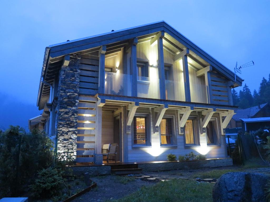 a house with lights on the front of it at Chalet de la Royotte - Sauna & SPA in Gérardmer