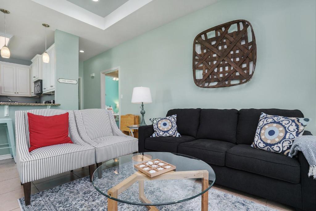 a living room with a couch and a table at Sea Glass Cottage in Crystal Beach