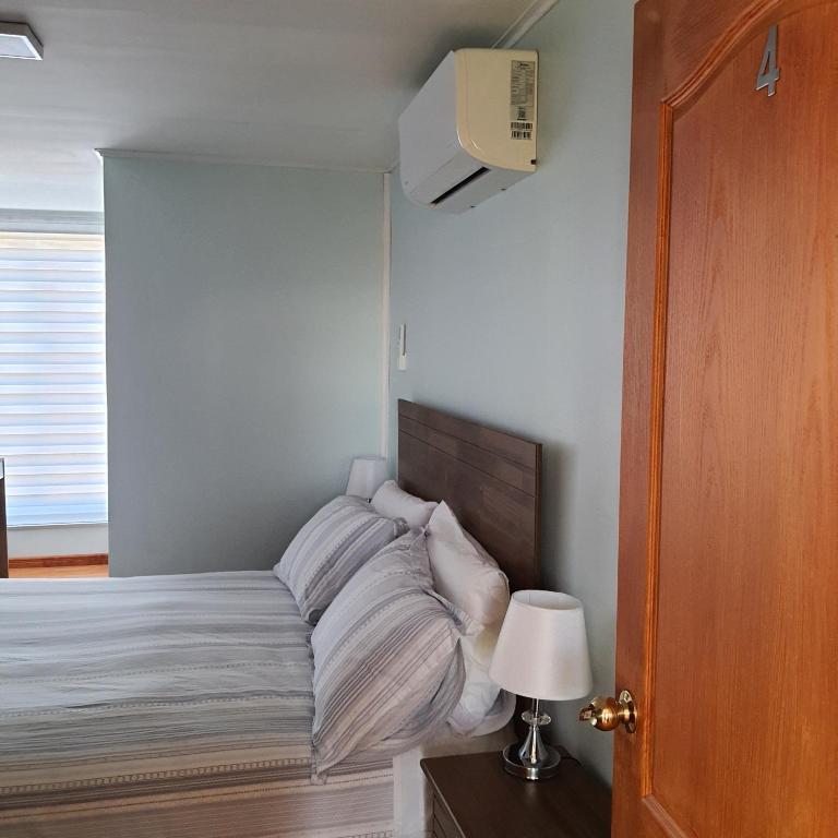 Rúm í herbergi á Hostal Ejecutivo