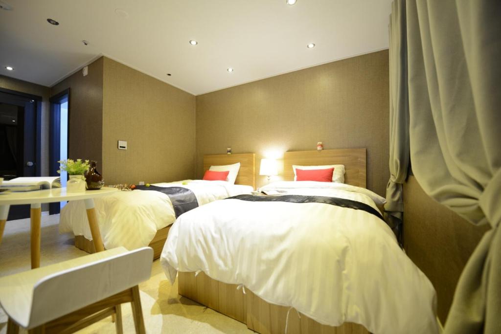 Postel nebo postele na pokoji v ubytování Dunsan Graytone Hotel
