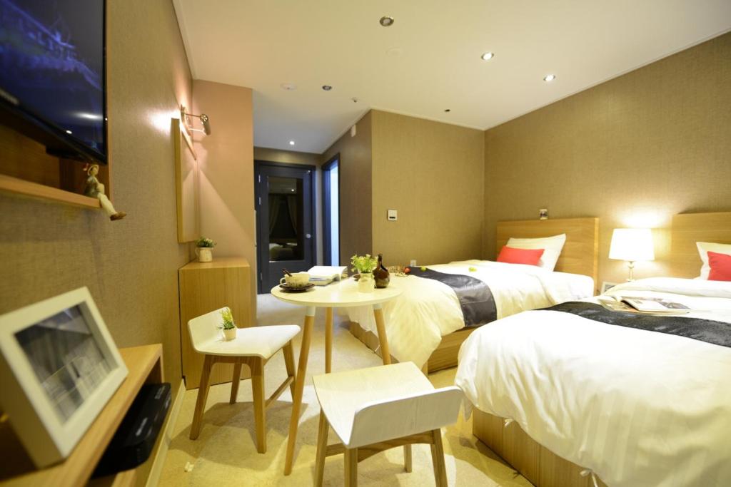 Postel nebo postele na pokoji v ubytování Dunsan Graytone Hotel