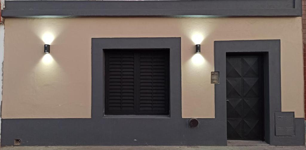 a building with two doors and two lights on it at Casa Termas in Termas de Río Hondo