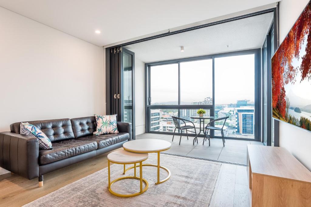 a living room with a couch and a table at Utopia Apartments by Serain Residences in Brisbane