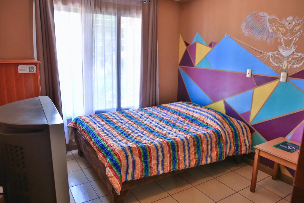 Postel nebo postele na pokoji v ubytování Mangifera Hostel