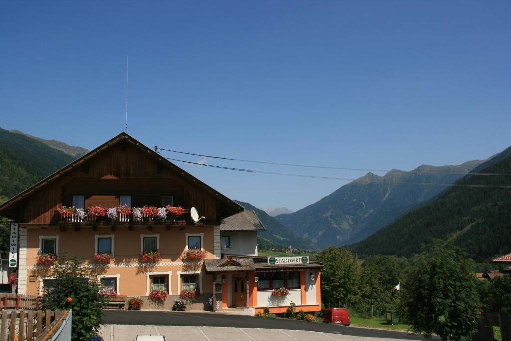 a building with flower boxes on the front of it at Hotel Stadlwirt in Rangersdorf