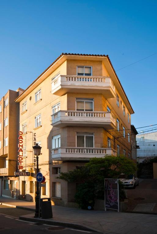 a tall building on the corner of a street at Hotel Cachalote in Portonovo