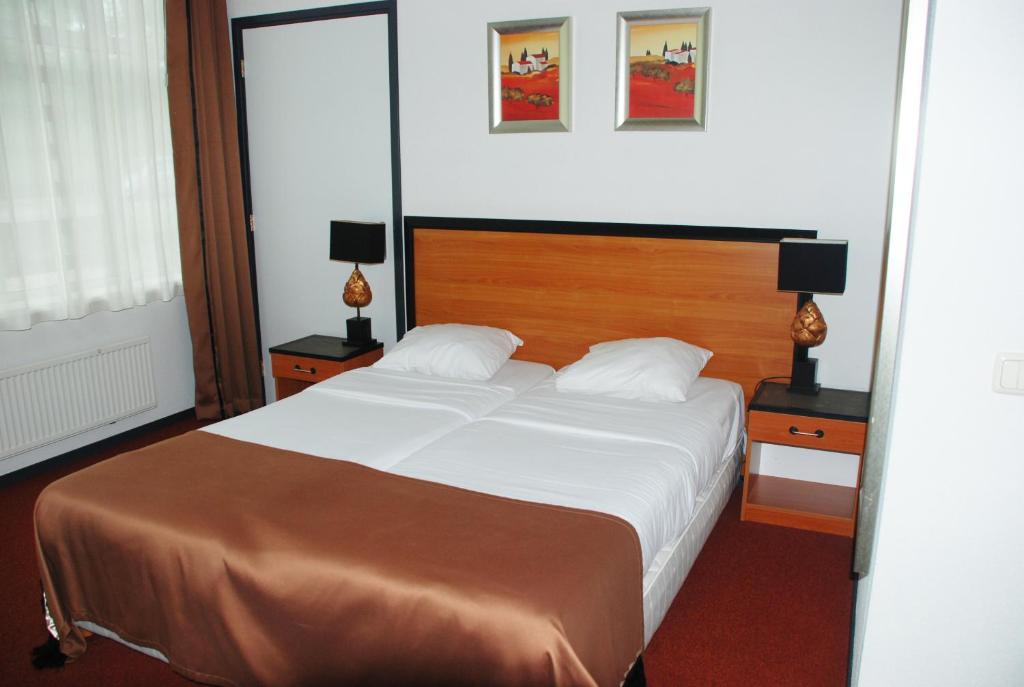 Postel nebo postele na pokoji v ubytování Fletcher Hotel Apeldoorn