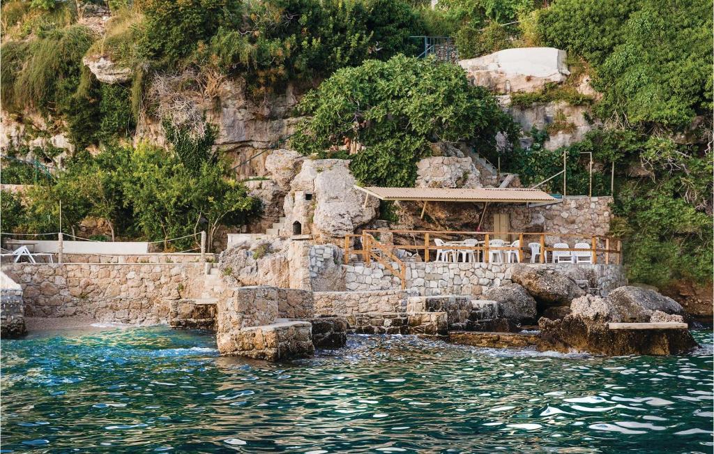 a building on a cliff next to the water at Nice Apartment In Omis With 3 Bedrooms And Wifi in Pisak