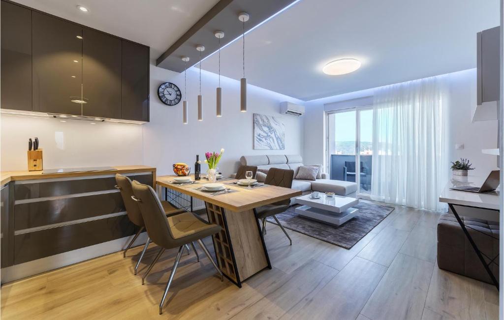a kitchen and dining room with a table and chairs at Cozy Apartment In Pula With Wifi in Pula