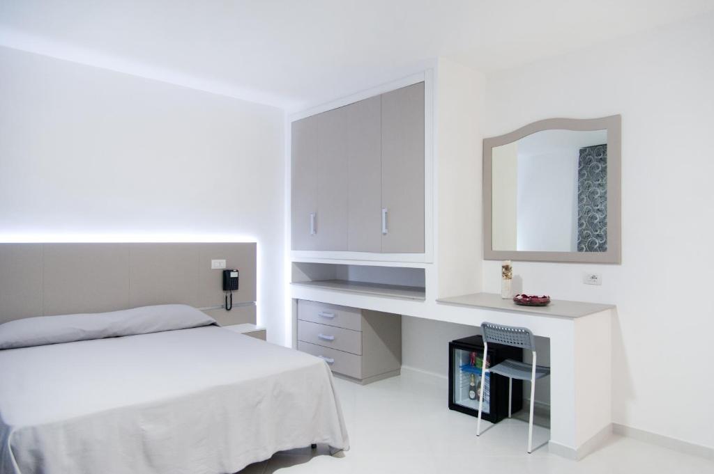 Łóżko lub łóżka w pokoju w obiekcie Hotel Regina