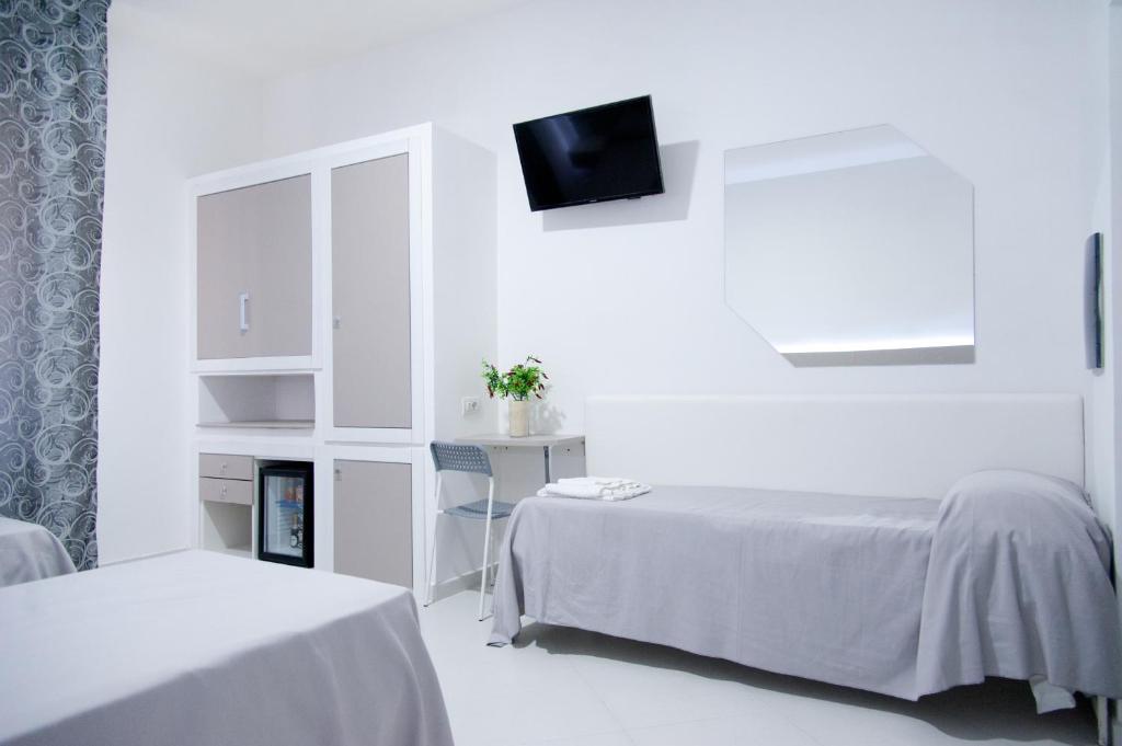 Łóżko lub łóżka w pokoju w obiekcie Hotel Regina