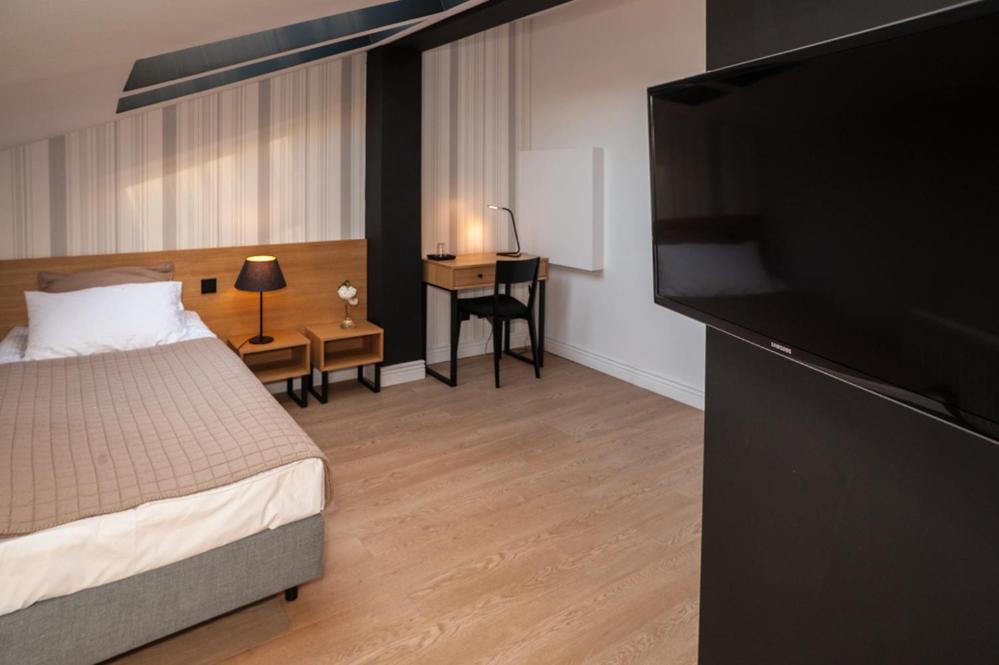 Postel nebo postele na pokoji v ubytování Qbatura Cafe & Hotel