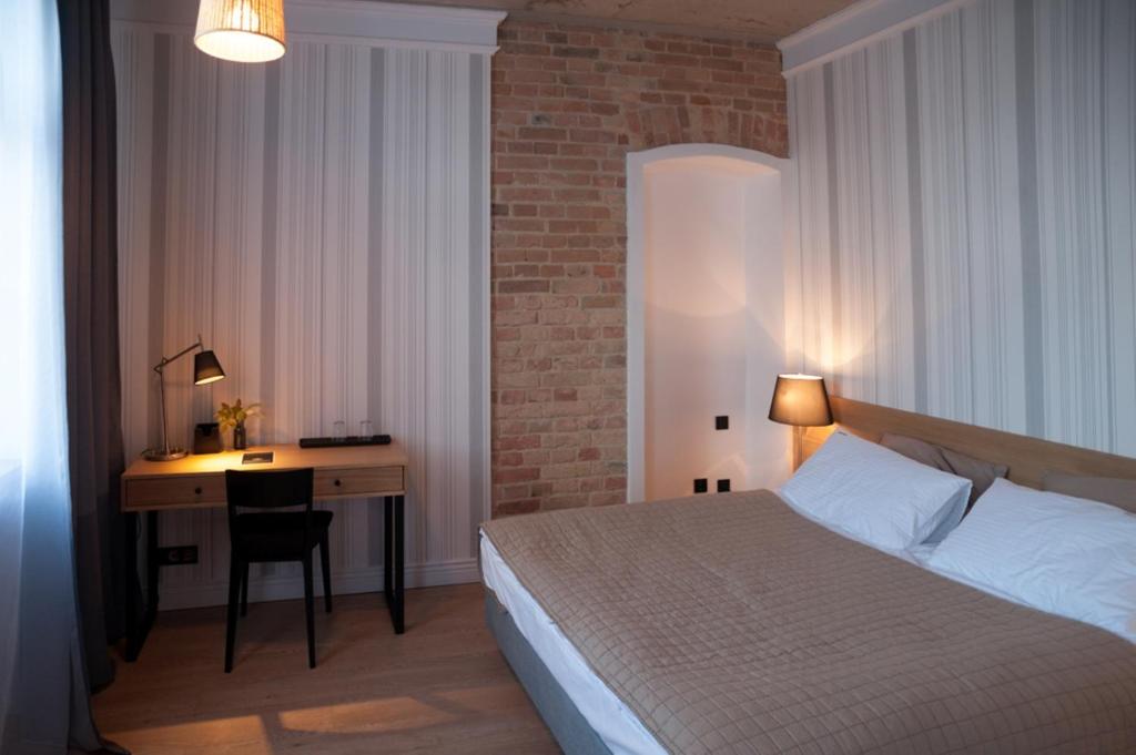 Postel nebo postele na pokoji v ubytování Qbatura Cafe & Hotel
