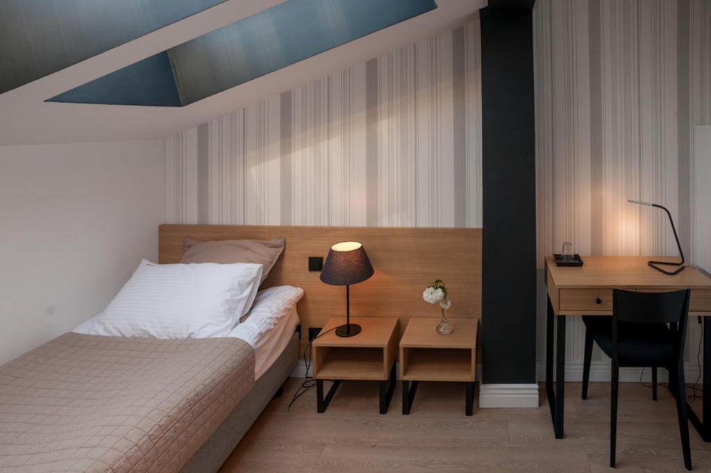 Postel nebo postele na pokoji v ubytování Qbatura Cafe & Hotel