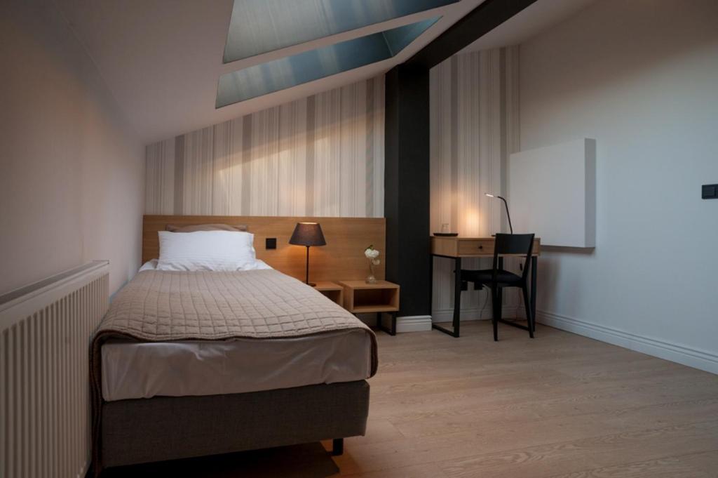 Postel nebo postele na pokoji v ubytování Qbatura Cafe & Hotel