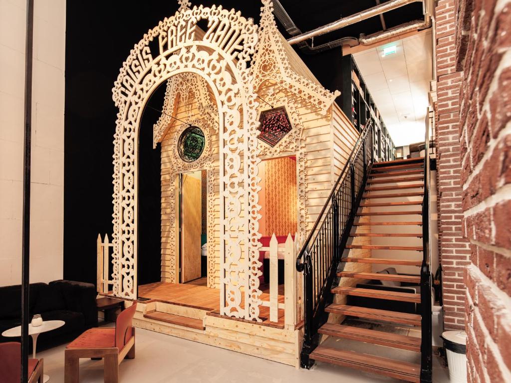 a model of a gingerbread house on a staircase at Hotel Not Hotel Amsterdam in Amsterdam