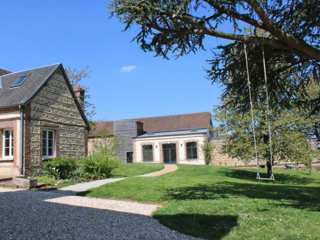 a house with a swing in the yard at Appartement L'Aigle, 2 pièces, 6 personnes - FR-1-497-140 in LʼAigle