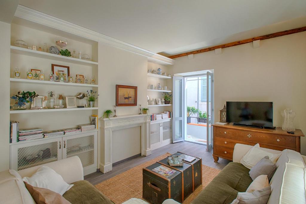 a living room with a couch and a tv at Heraclea Residential Apartments in Hvar