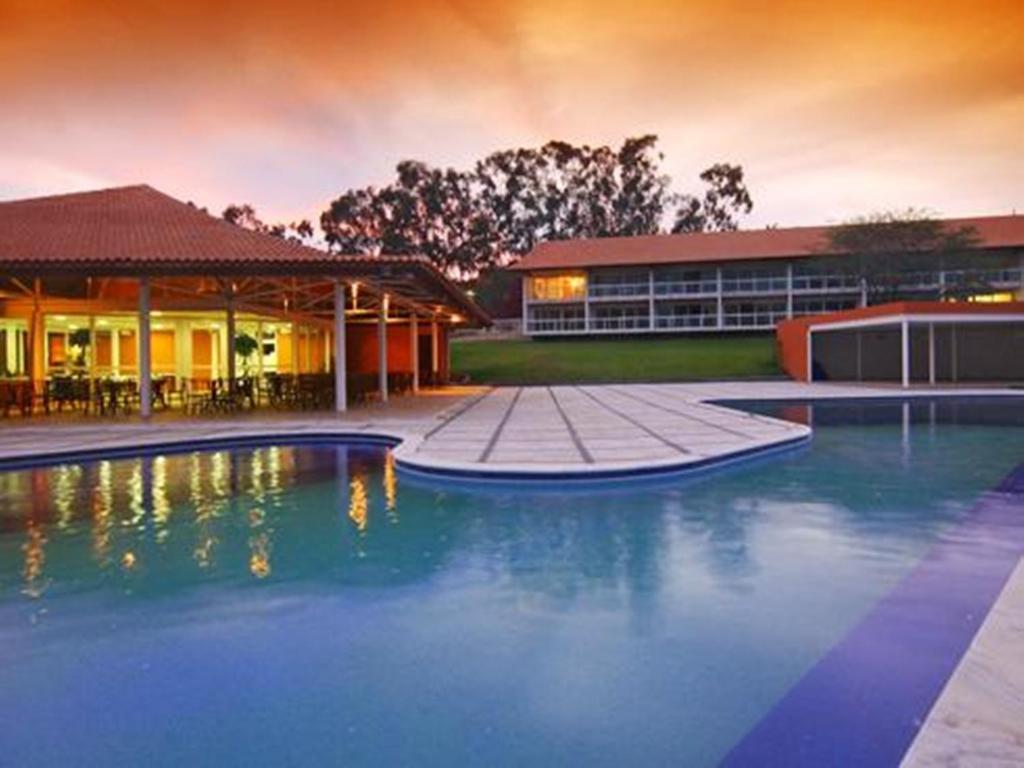 a large pool of water in front of a building at Flat no Villa Hípica - Gravatá in Gravatá