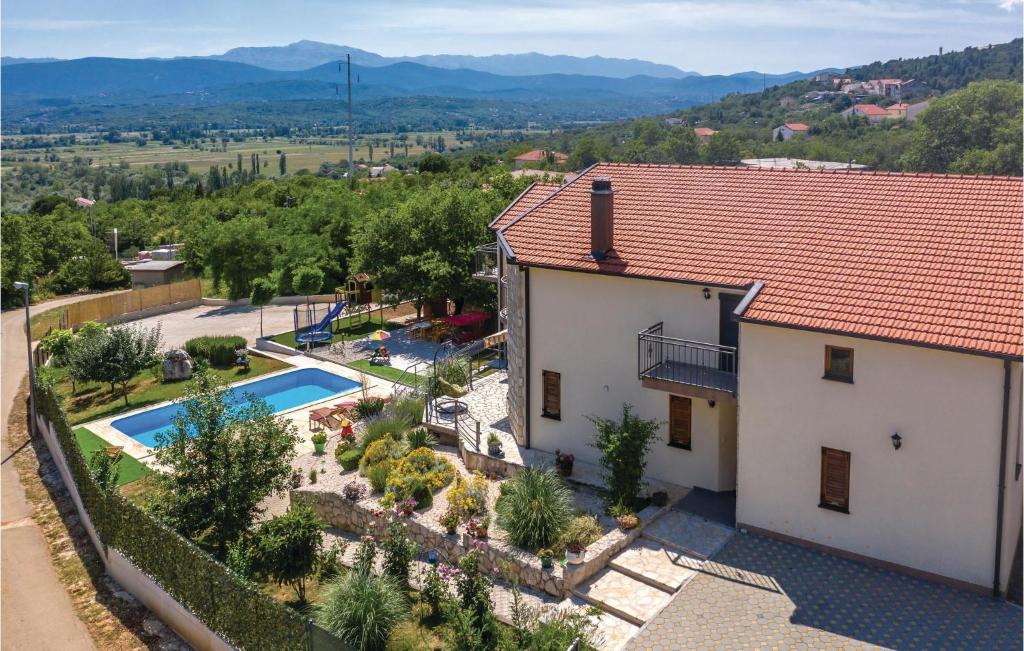 an aerial view of a house with a swimming pool at Stunning Home In Vinjani Donji With 5 Bedrooms, Wifi And Outdoor Swimming Pool in Majići