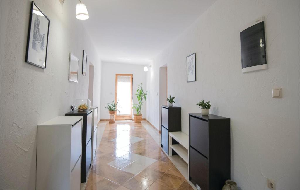 a hallway with black and white cabinets and a tile floor at Stunning Home In Vinjani Donji With 5 Bedrooms, Wifi And Outdoor Swimming Pool in Majići