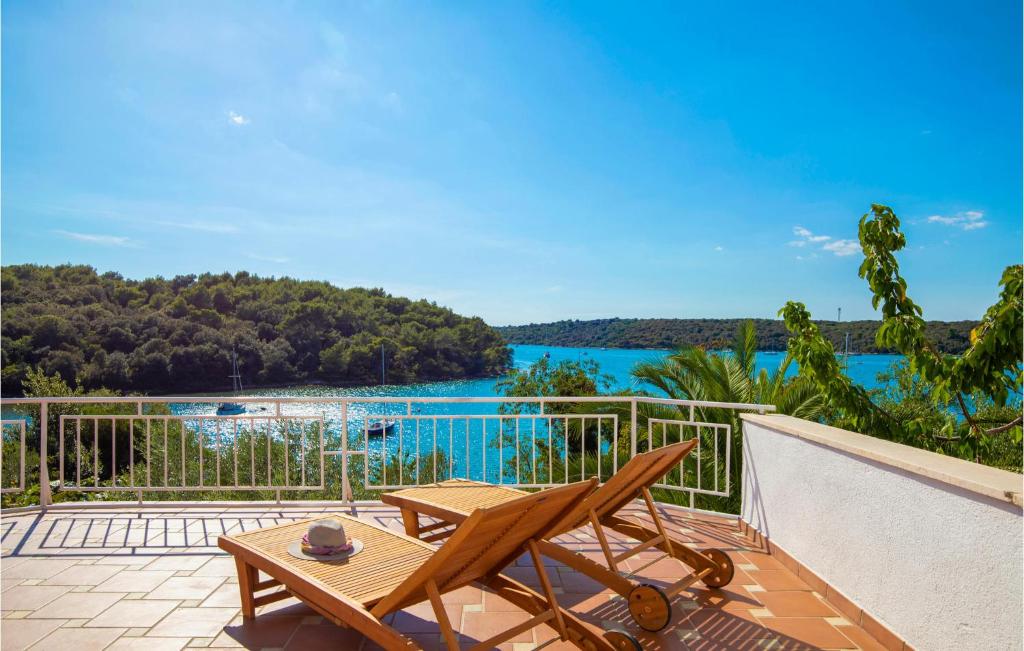 a patio with a table and a chair on a balcony at 2 Bedroom Amazing Apartment In Pula in Pula