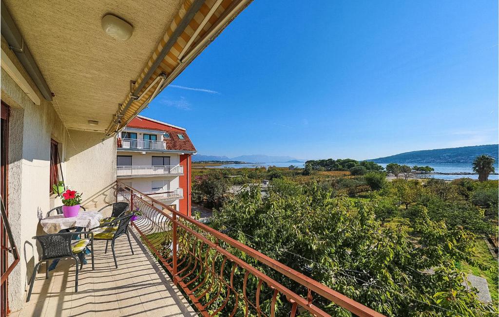 a balcony with a table and chairs on a building at Beautiful Apartment In Trogir With Wifi in Trogir