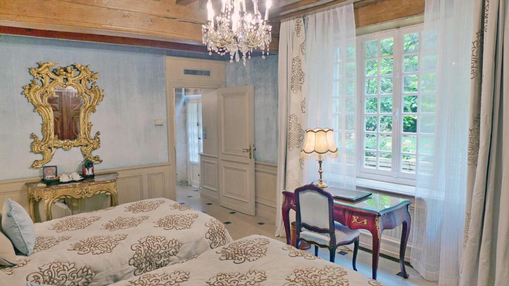 Postel nebo postele na pokoji v ubytování Hôtel Le Cep & Spa