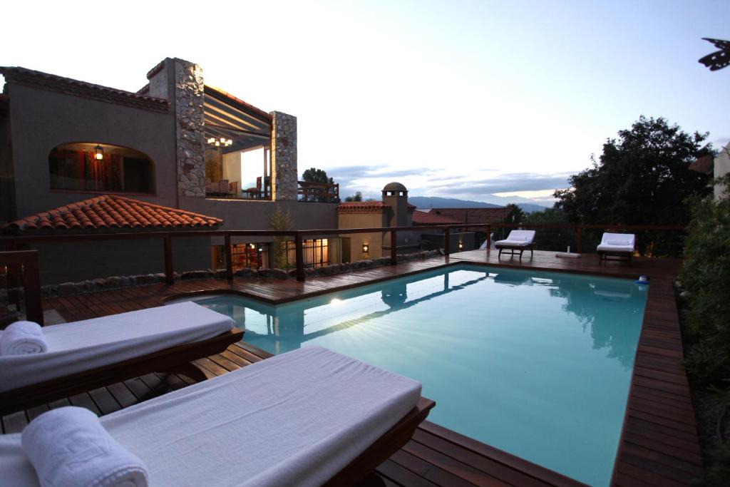 a swimming pool on top of a house at Kkala Boutique Hotel in Salta