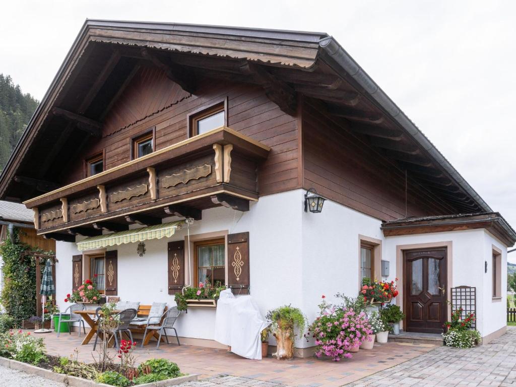 a house with a wooden roof and a patio at Lovely Apartment in Kleinarl near Ski Area in Kleinarl