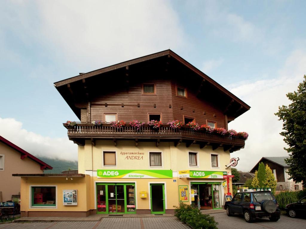 a building with a balcony with flowers on it at Beautiful Apartment in Uttendorf with Balcony in Uttendorf