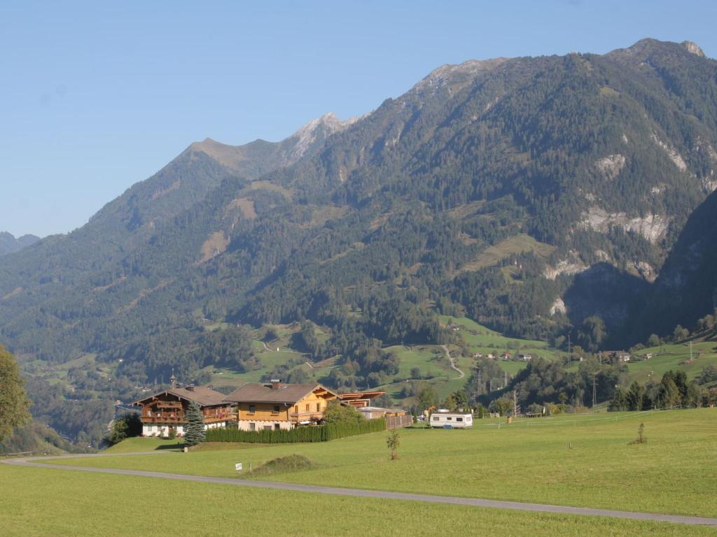 a house in a field in front of a mountain at Apartment in Embach Austria near ski area in Embach