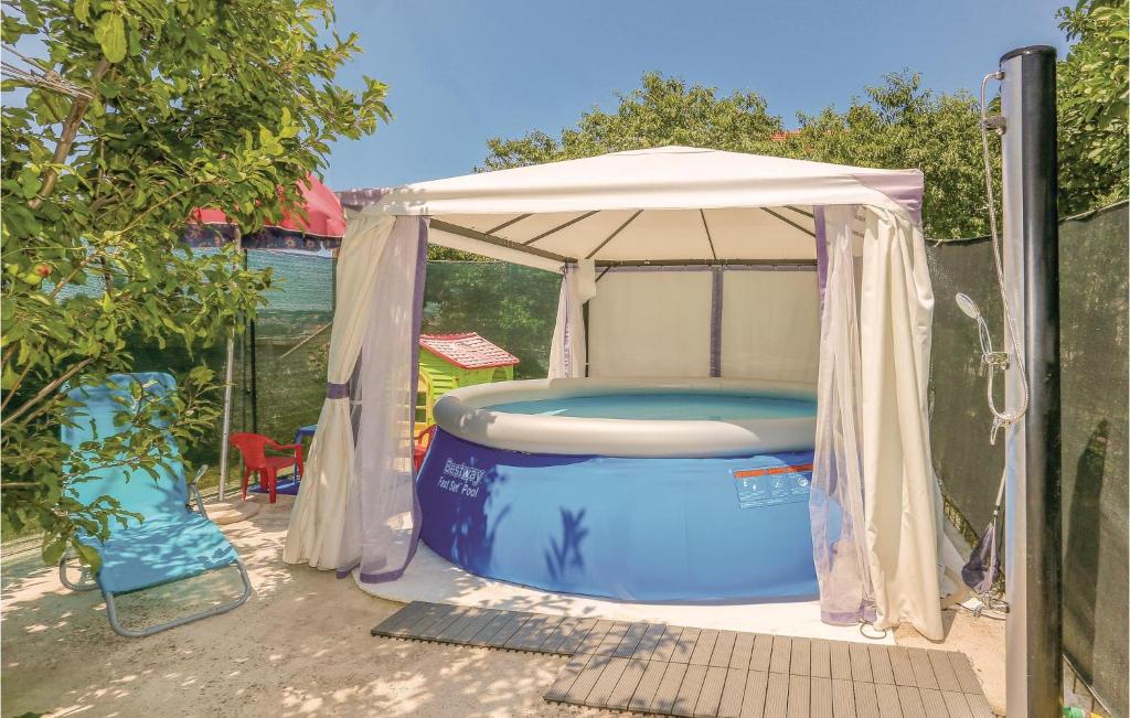 a gazebo with a pool in a backyard at Amazing Home In Podstrana With Kitchen in Podstrana
