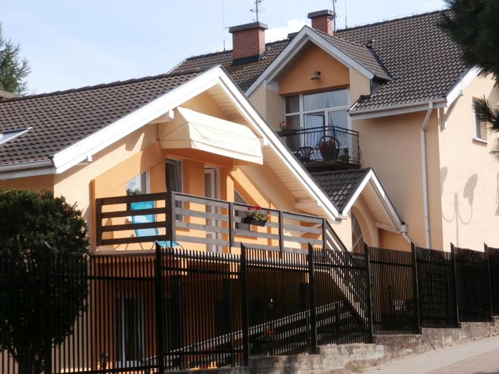 a house with a fence in front of it at Pokoje Gościnne - Noclegi Charzykowy in Charzykowy